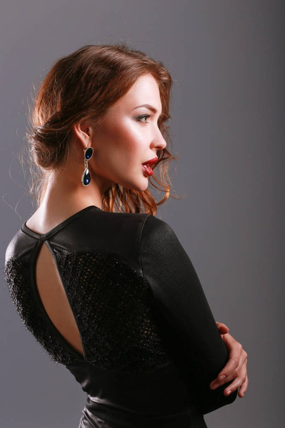 Beautiful woman with evening make-up in black dress - Фото, изображение