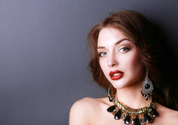 Beautiful woman with evening make-up in black dress - 写真・画像