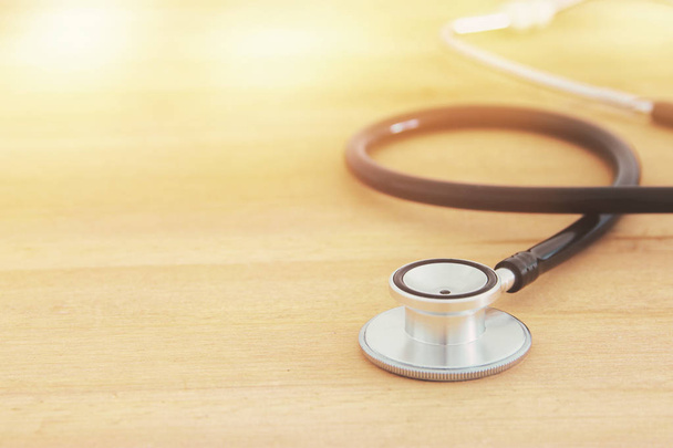 Image of stethoscope over wooden desk. Medical concept. - Fotó, kép