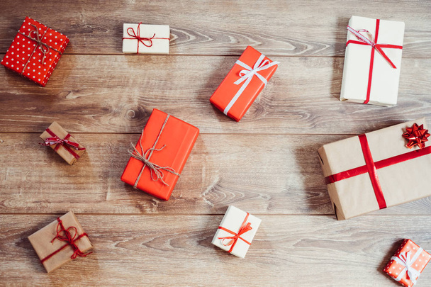 Sparse christmas gifts on wooden background - Photo, Image