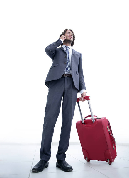 bottom view.businessman with Luggage talking on a cell - Foto, immagini
