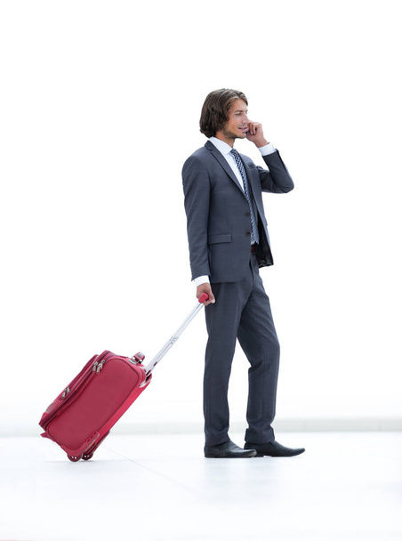 businessman with Luggage talking on a cell phone. - Фото, изображение