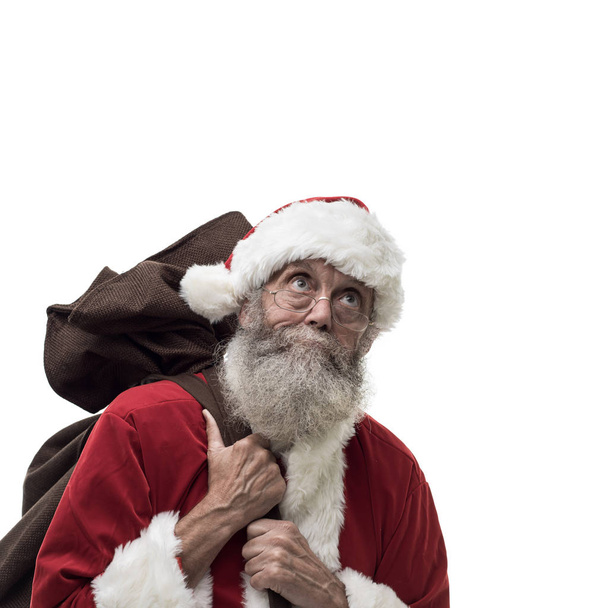 Santa Claus carrying Christmas gifts - 写真・画像