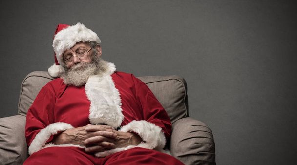 Santa Claus napping on the armchair - Фото, изображение