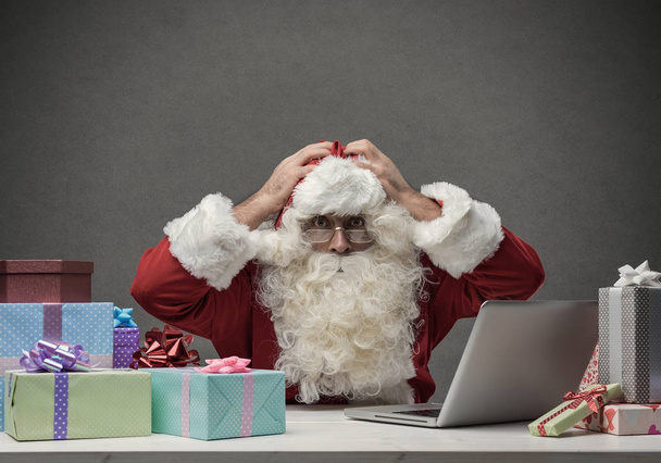 Stressed Santa connecting with his laptop - Foto, Bild