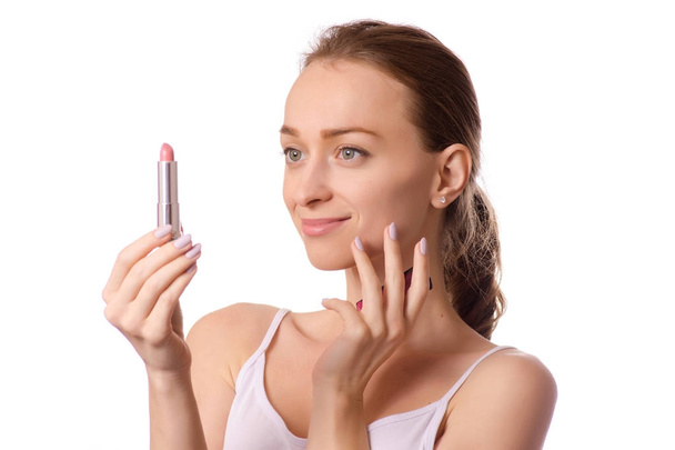 Beautiful young woman wearing lipstick in hand - Photo, image
