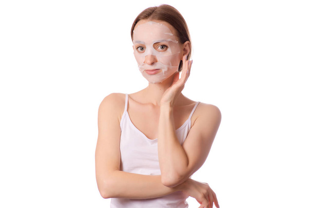 Beautiful young woman a tissue mask on her face beauty cosmetics - Foto, Bild