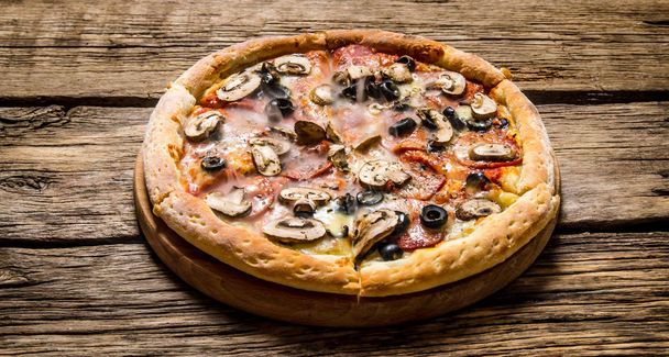 Italian pizza with olives and bacon .  - Фото, изображение