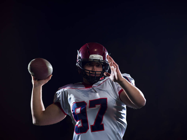 american football player throwing rugby ball - Fotó, kép