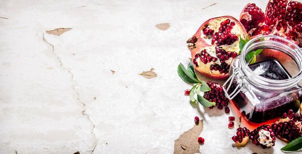 Pomegranate juice with bits of pomegranates and leaves.  - Photo, Image