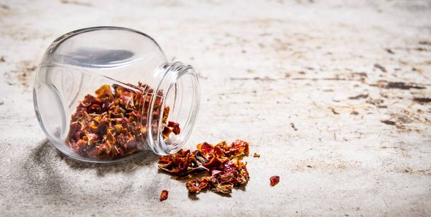 Dried red Chili peppers in the jar. On rustic background. - Fotoğraf, Görsel