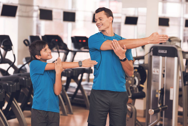 Dad and son in the same clothes in gym. Father and son lead a healthy lifestyle. - Φωτογραφία, εικόνα