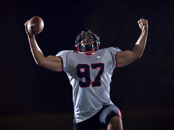 american football player celebrating after scoring a touchdown - Valokuva, kuva