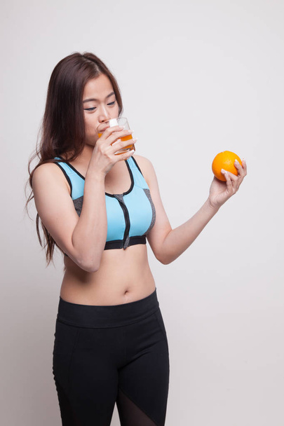 Beautiful Asian healthy girl with orange juice and orange fruit. - Zdjęcie, obraz