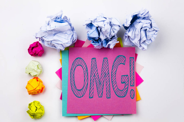 Writing text showing OMG Oh My God written on sticky note in office with screw paper balls. Business concept for Surprise Humor on the white isolated background. - Photo, Image