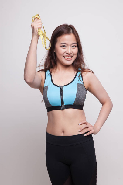 Beautiful Asian healthy girl with measuring tape. - Foto, imagen