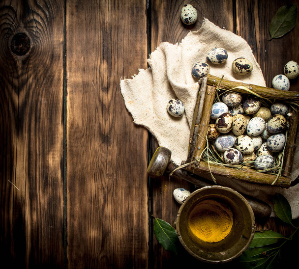 Quail eggs in basket and ground spices in a mortar. - Valokuva, kuva