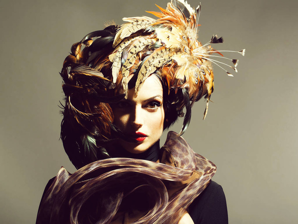 pretty sexy woman in feather hat - Фото, изображение