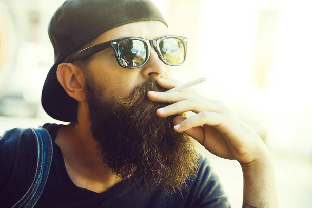 Young man hipster smoking cigarette - Photo, image