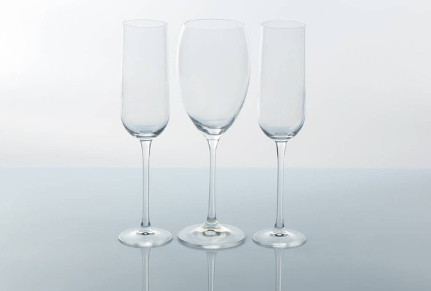 three empty wine glass on a light backgroun - Foto, Imagem