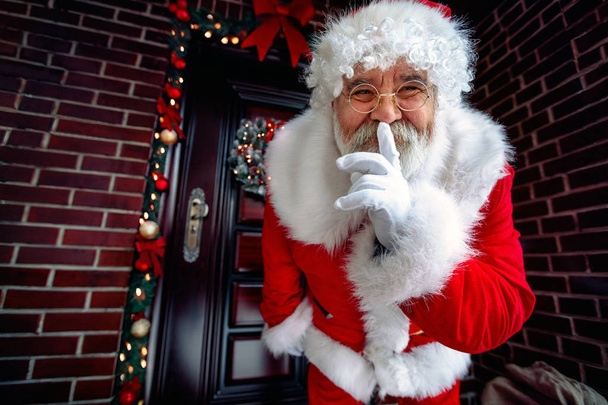 Portrait of Happy Santa Claus with finger on lips - Фото, изображение