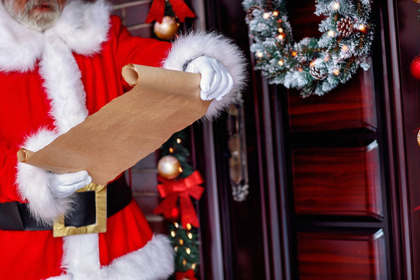 Santa list- Santa Claus holding scroll paper - Foto, Imagem