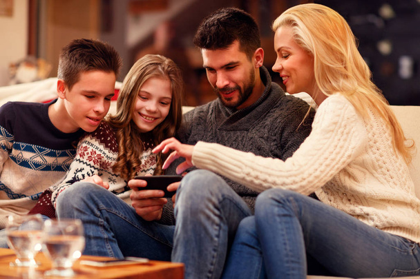 Family having fun on digital tablet for Christmas - Foto, afbeelding