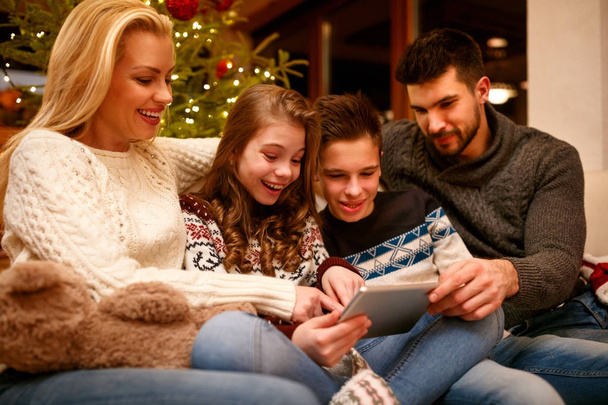 happy family having fun on digital tablet for Christmas - Photo, Image