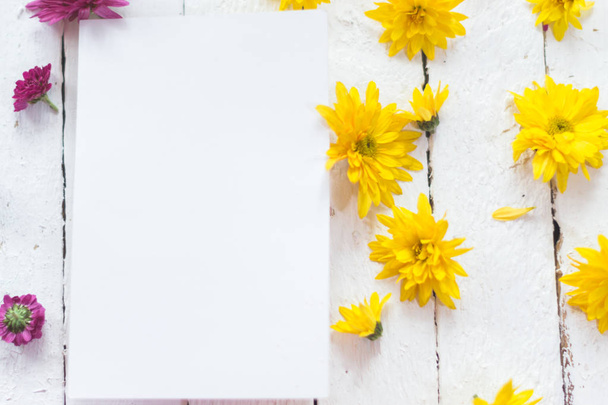 Multicolored flowers on a white wooden mocap background. - Φωτογραφία, εικόνα