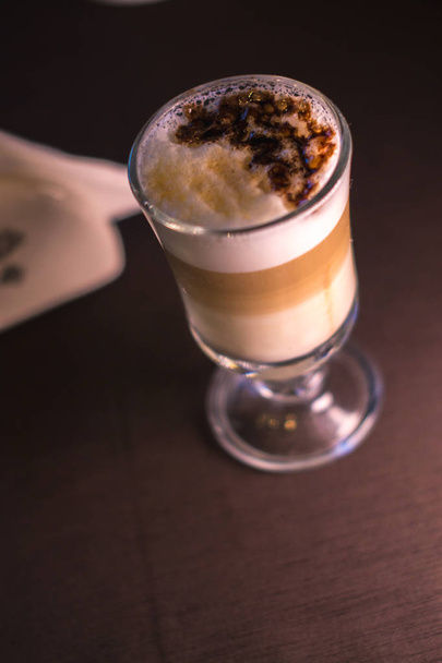 Coffee in a glass cup in a cafe with a blurred background. - Fotoğraf, Görsel