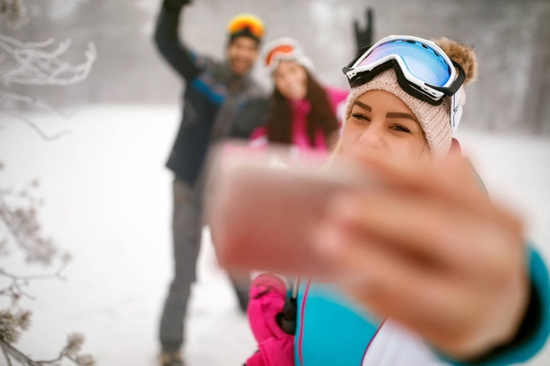 friends making winter selfie in the mountain on winter holiday - Zdjęcie, obraz