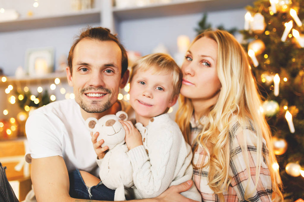 Beautiful family in Christmas interior - Photo, image