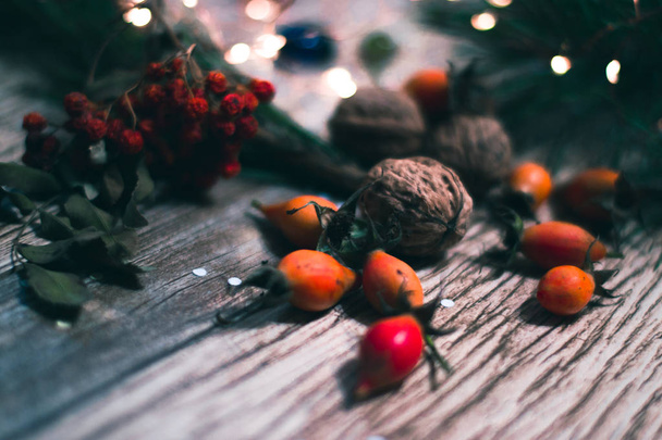 Berries and nuts on wooden boards with a blurred background. - Foto, imagen