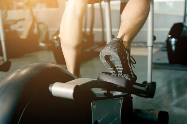 Hombre corriendo en un gimnasio en una cinta de correr para hacer ejercicio
. - Foto, imagen