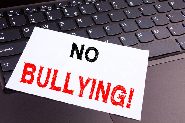 No Bullying writing text made in the office close-up on laptop computer keyboard. Business concept for Bullies Prevention Against School Work or in the Cyber Internet Harassment the black background - Photo, Image