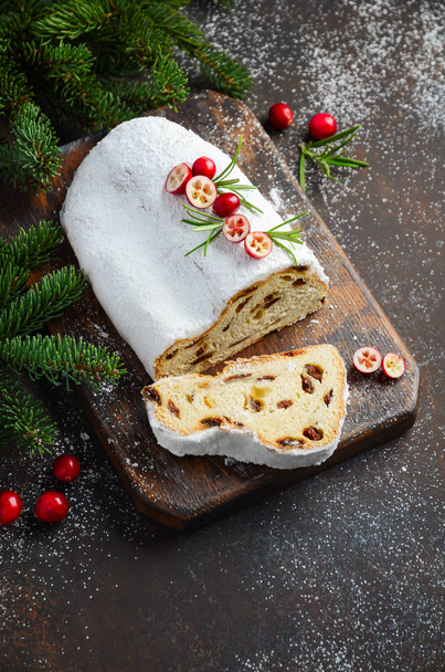 Christmas Stollen. Traditional German, European Festive Dessert. Holiday Concept Decorated with Fir Branches and Cranberries. - Valokuva, kuva
