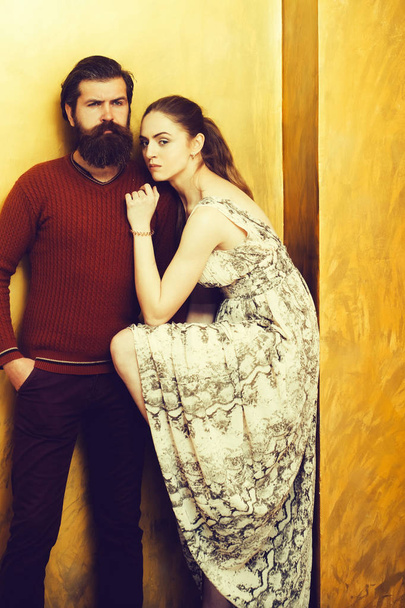 Serious bearded man and pretty girl with raised sexi leg - Фото, зображення