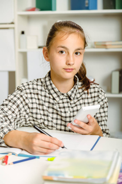Teenage girl preparing for exams. Teenage girl doing homework . - Fotó, kép