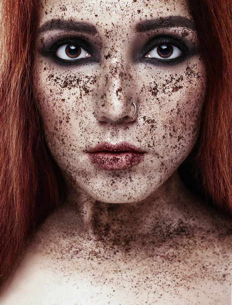 Beautiful european Girl with Red hair. Portrait of a young woman with perfect skin on her face, scrub the skin. Face scrub. Beauty concept - 写真・画像