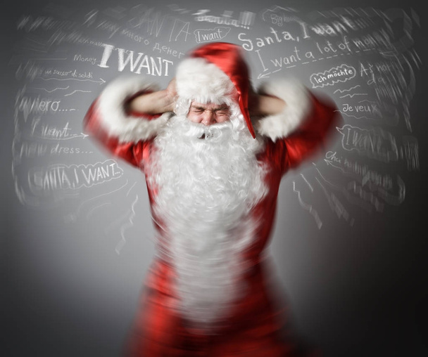 Frustrated Santa Claus and many wishes. Headache concept. - Photo, Image