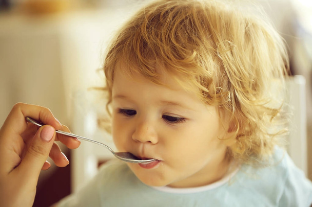 Baby boy fed with spoon - Fotoğraf, Görsel
