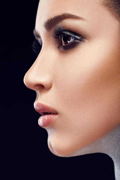 Close-up image of great beauty art make-up. Beauty. Beautiful Woman Face With soft color Lipstick. Sexy Full Lips. Portrait Of Female Model With Natural Makeup. Cosmetics Concept. Skincare concept - Photo, image
