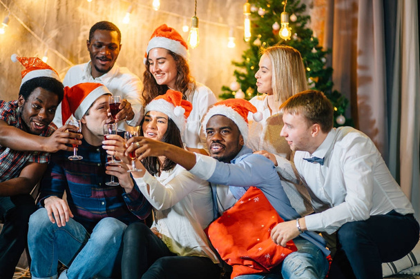 Friends Enjoying Christmas Drinks In Bar - Фото, изображение