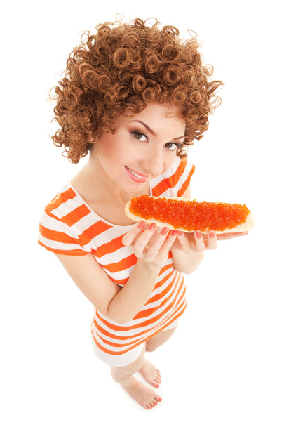 fun woman eating the sandwich with red caviar on the white backg - Photo, Image