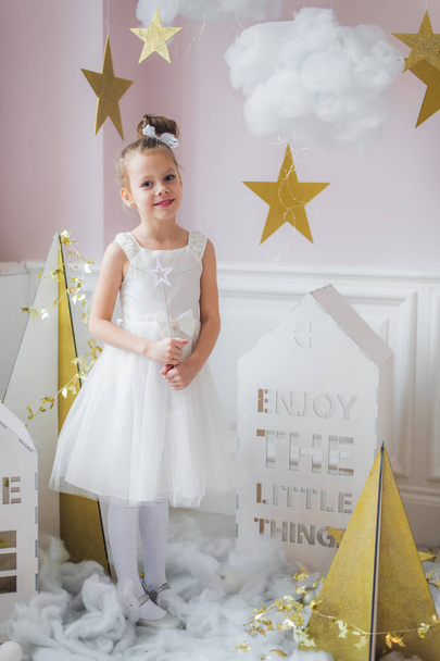 Adorable little fairy girl with magic wand at christmas decorations indoors - Photo, Image