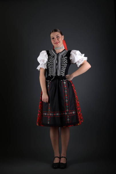 Young beautiful slovak folklore woman in traditional costume - Foto, afbeelding