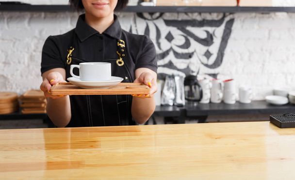 Portrait of young barista at coffee shop counter - Photo, Image