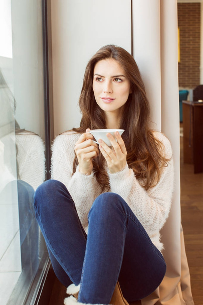 Beautiful Woman With Coffee by the window - Foto, afbeelding