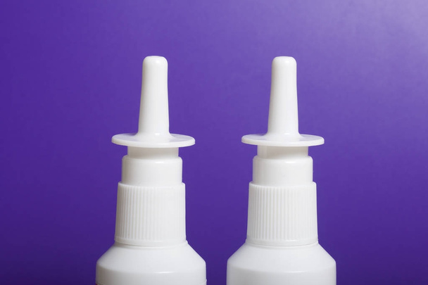 Nasal spray stand on the surface. On a lilac background. - Photo, image