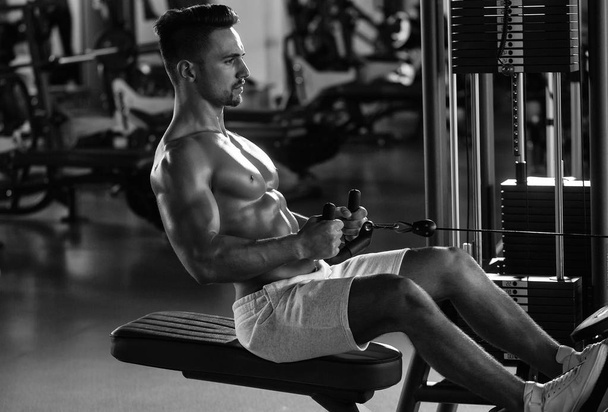 muscular man training in gym - Photo, image
